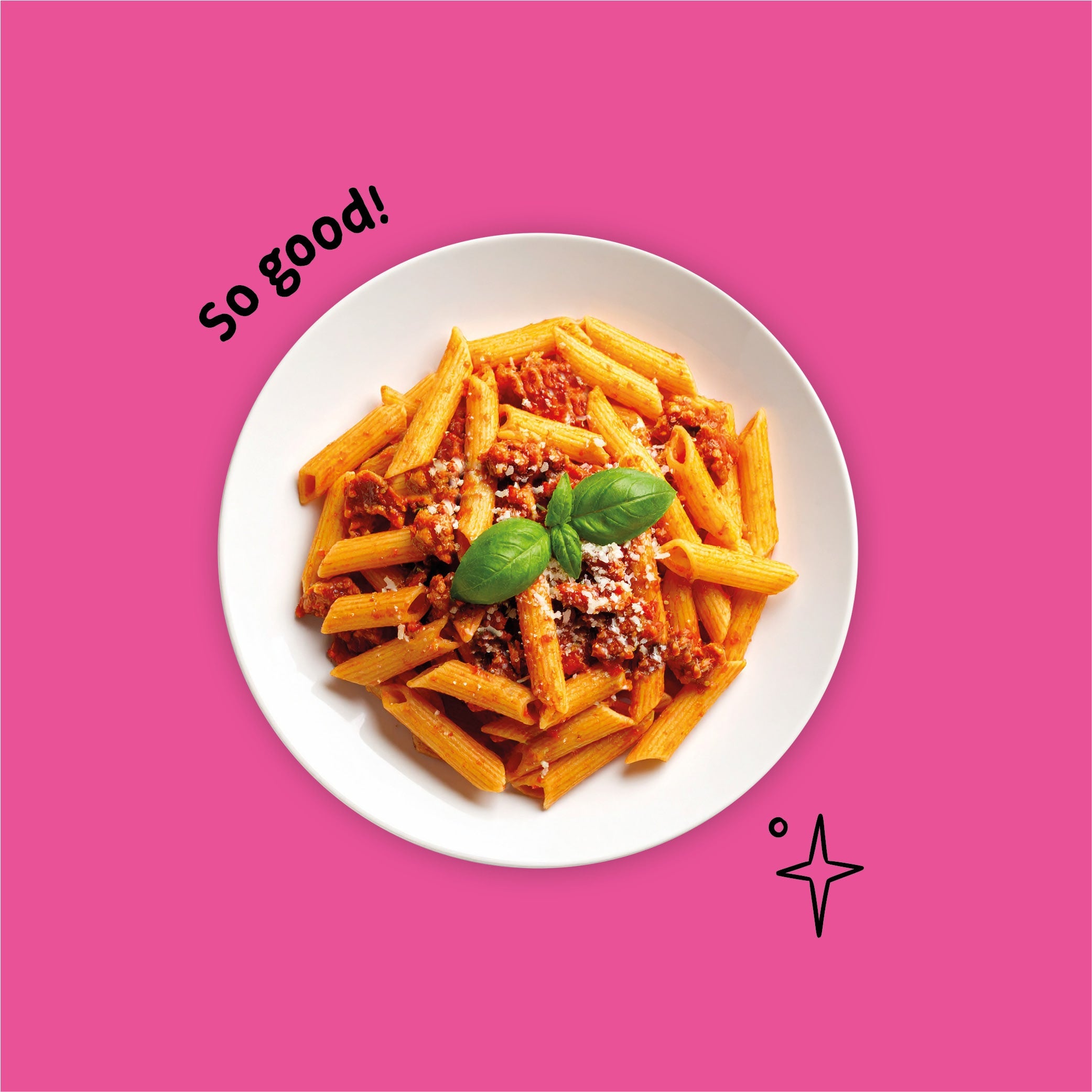 Gluten-free penne pasta with arrabbiata sauce, sausage and basil on a white plate against a pink background